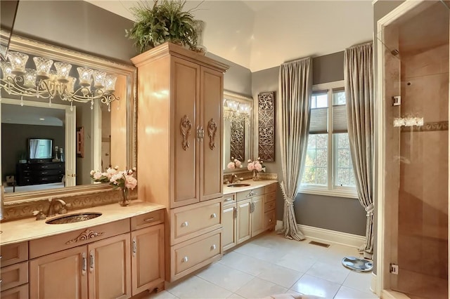 107 Mirage Dr, Cranberry Twp, PA 16066 - full bathroom with tile patterned floors, a chandelier, two vanities, and baseboards