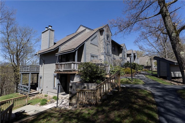 4308 Swiss Mountain Dr, Seven Springs Resort, PA 15622 - view of property exterior with a chimney, roof with shingles, and a deck