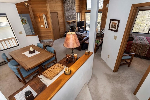 4308 Swiss Mountain Dr, Seven Springs Resort, PA 15622 - carpeted living room with plenty of natural light, wooden walls, baseboard heating, and a stone fireplace