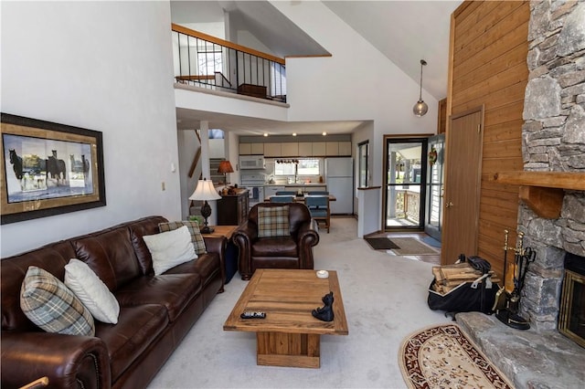 4308 Swiss Mountain Dr, Seven Springs Resort, PA 15622 - carpeted living room with high vaulted ceiling, a stone fireplace, stairs, and a sink