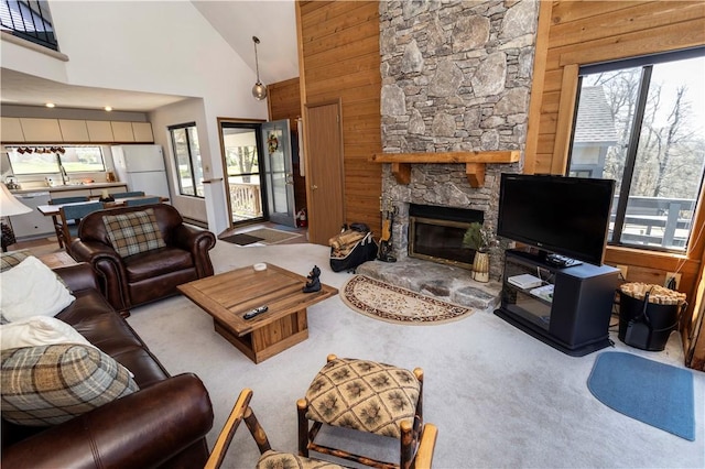 4308 Swiss Mountain Dr, Seven Springs Resort, PA 15622 - living area with carpet flooring, a fireplace, wood walls, and high vaulted ceiling