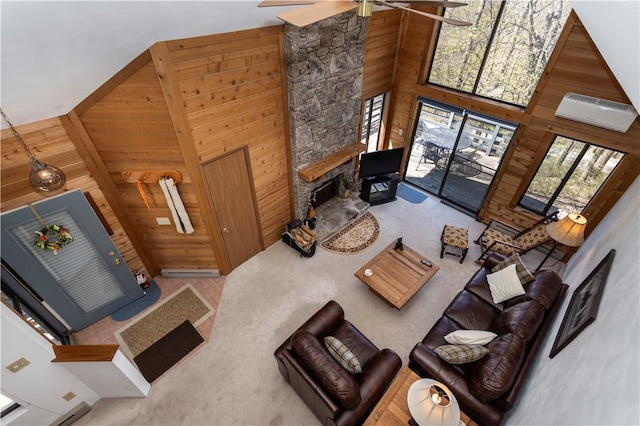 4308 Swiss Mountain Dr, Seven Springs Resort, PA 15622 - living room featuring ceiling fan, wood walls, a fireplace, a high ceiling, and carpet flooring