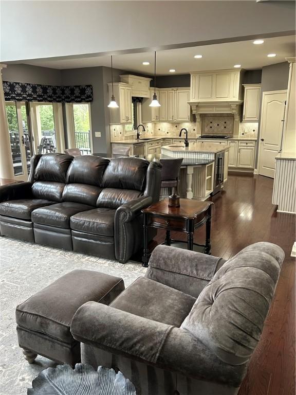 living area featuring dark wood-style flooring and recessed lighting