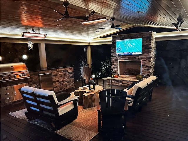 deck with area for grilling, grilling area, ceiling fan, and an outdoor living space with a fireplace