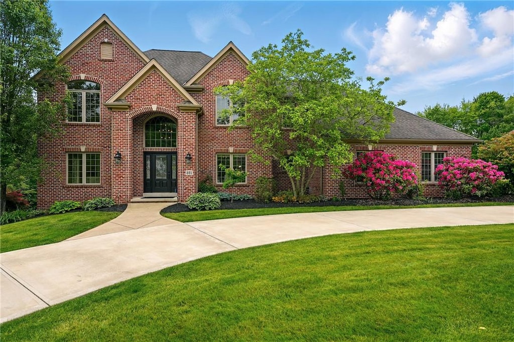 221 Cashmere Ct, Cranberry Twp, PA 16066 - view of front of house with a front yard, brick siding, and french doors