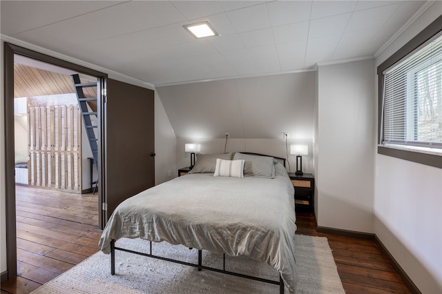 bedroom featuring hardwood / wood-style flooring, crown molding, and baseboards