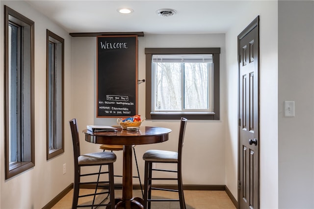 dining area with baseboards and recessed lighting