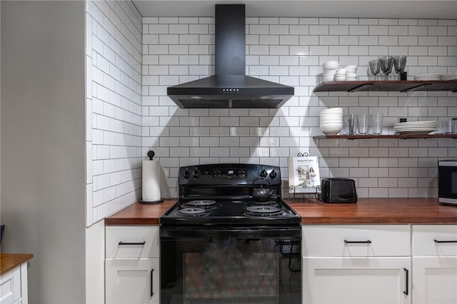 kitchen with butcher block counters, electric range, wall chimney range hood, and tasteful backsplash