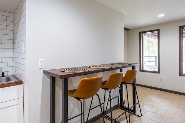 dining area with recessed lighting and baseboards