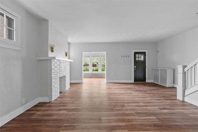 1140 N Negley Ave, Highland Park, PA 15206 - unfurnished living room with stairway, wood finished floors, baseboards, and a fireplace