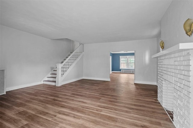 1140 N Negley Ave, Highland Park, PA 15206 - unfurnished living room with stairs, wood finished floors, a fireplace, and baseboards