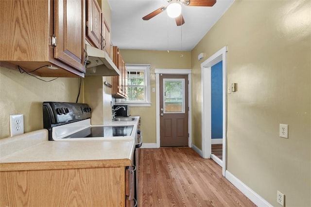 1140 N Negley Ave, Highland Park, PA 15206 - kitchen with under cabinet range hood, range with electric cooktop, light wood-type flooring, light countertops, and ceiling fan