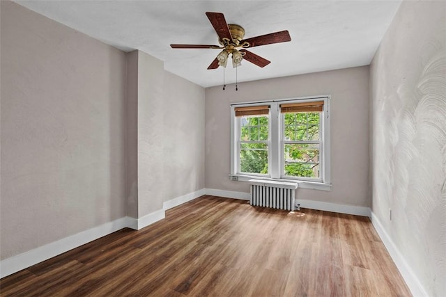 1140 N Negley Ave, Highland Park, PA 15206 - unfurnished room featuring radiator, wood finished floors, baseboards, and a ceiling fan
