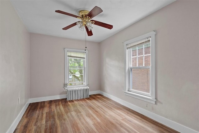 1140 N Negley Ave, Highland Park, PA 15206 - spare room featuring radiator, wood finished floors, baseboards, and a ceiling fan