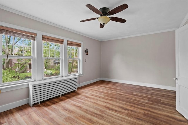 1140 N Negley Ave, Highland Park, PA 15206 - unfurnished room featuring radiator, baseboards, light wood-style flooring, a ceiling fan, and crown molding