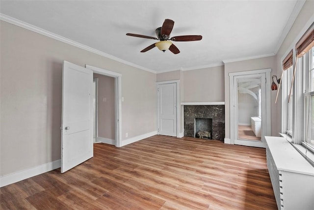 1140 N Negley Ave, Highland Park, PA 15206 - unfurnished living room with light wood-style floors, ornamental molding, a ceiling fan, baseboards, and a premium fireplace
