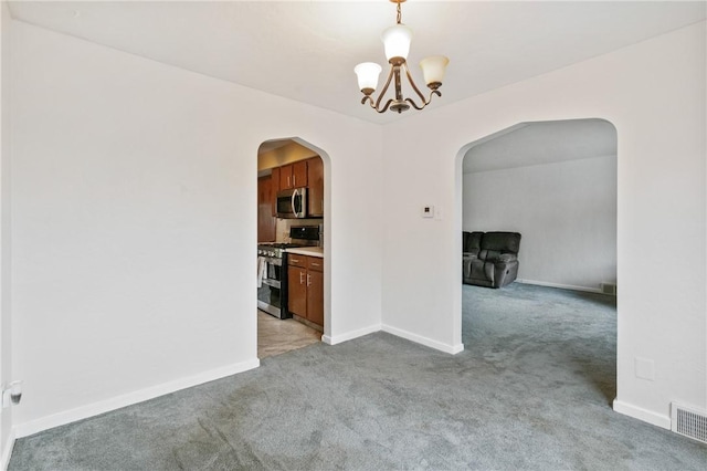 unfurnished dining area featuring arched walkways, light colored carpet, a chandelier, and baseboards