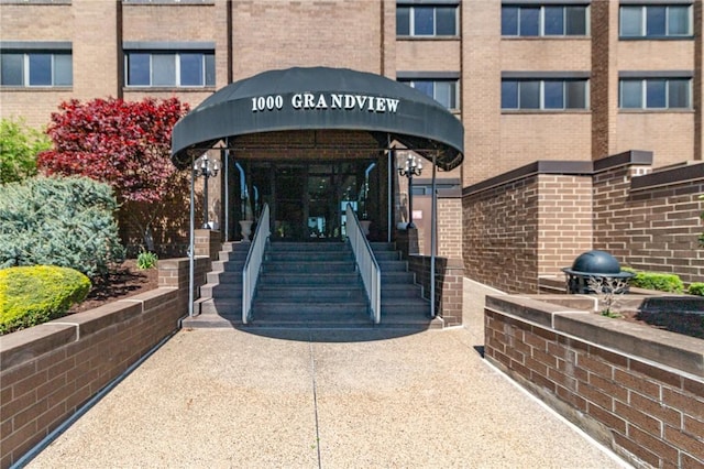 view of exterior entry with brick siding