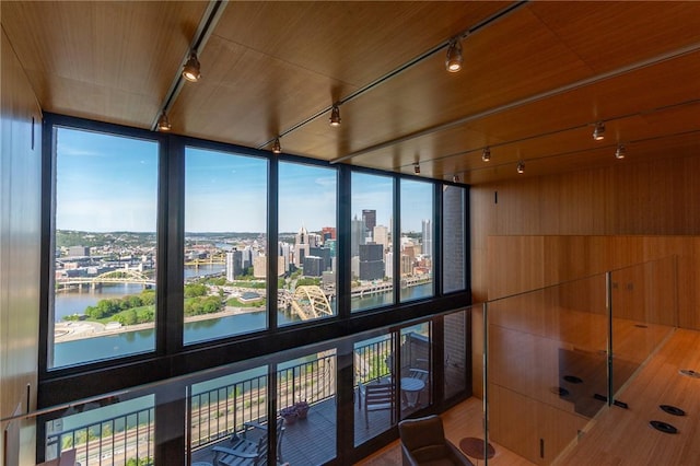 detailed view of track lighting, a city view, a water view, and wooden walls