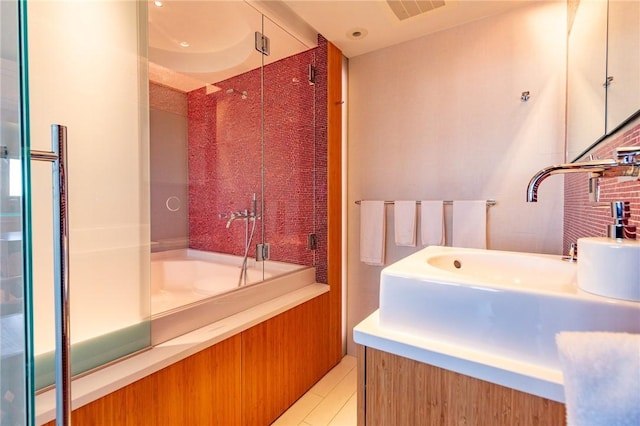 bathroom with a bath, tile patterned floors, a sink, and an enclosed shower