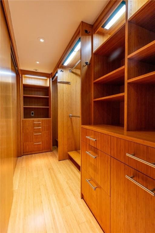 walk in closet featuring light wood finished floors