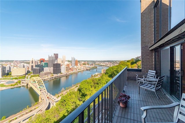 balcony with a water view and a city view