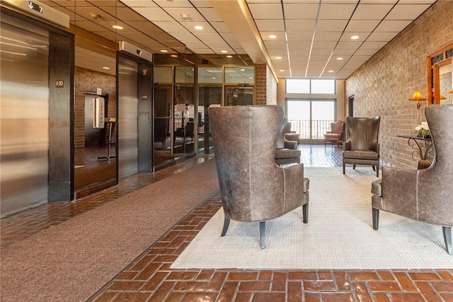 lobby featuring a paneled ceiling and recessed lighting