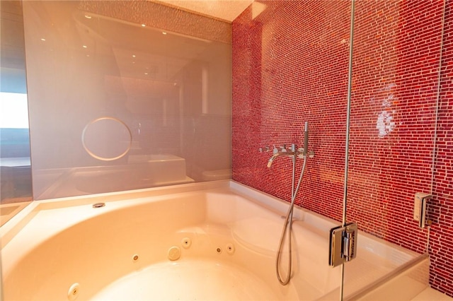 bathroom with a stall shower and a jetted tub