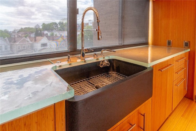 1000 Grandview Ave Unit 1207, Mt Washington, PA 15211 - kitchen view of a sink, brown cabinets, modern cabinets, and light wood-style floors