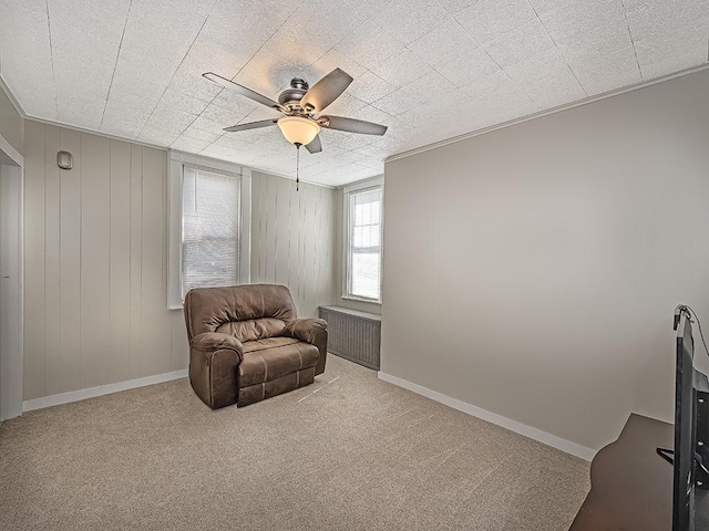sitting room featuring a ceiling fan and carpet