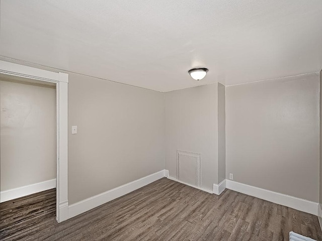 empty room with wood finished floors and baseboards