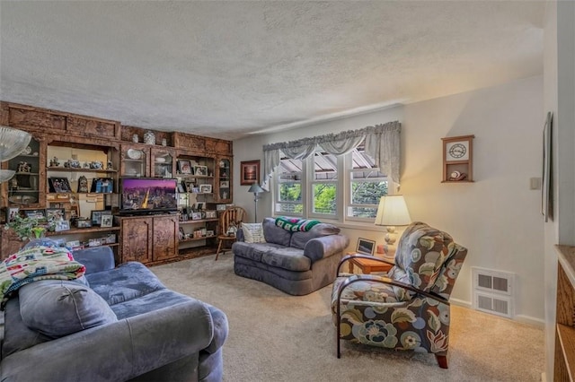 living area with carpet flooring, a textured ceiling, and baseboards