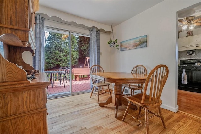 dining room with light wood-type flooring, a ceiling fan, and baseboards