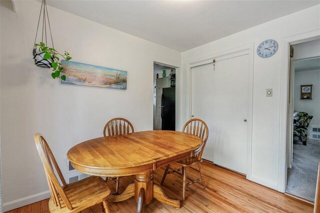 dining area featuring light wood-style flooring