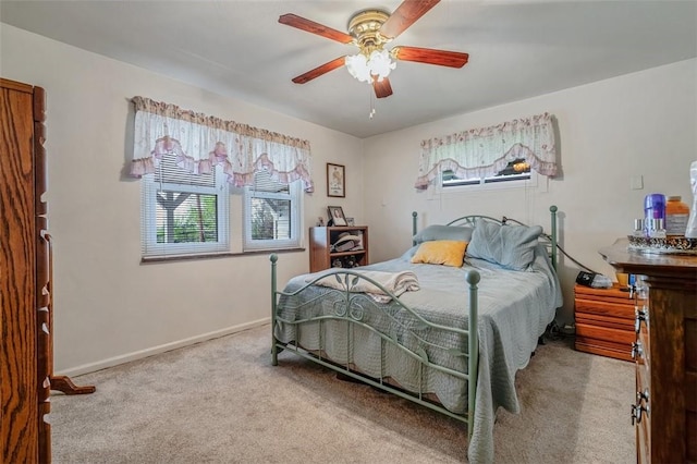 carpeted bedroom with baseboards and a ceiling fan