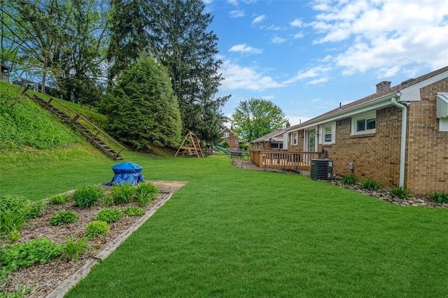 view of grassy yard featuring cooling unit and a deck