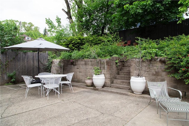 view of patio featuring fence and outdoor dining space