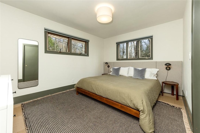 bedroom with multiple windows and baseboards
