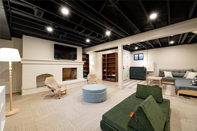 carpeted living area featuring a brick fireplace