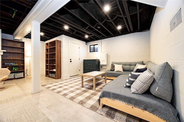 living room featuring concrete block wall