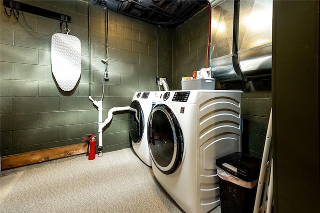 washroom with washing machine and clothes dryer