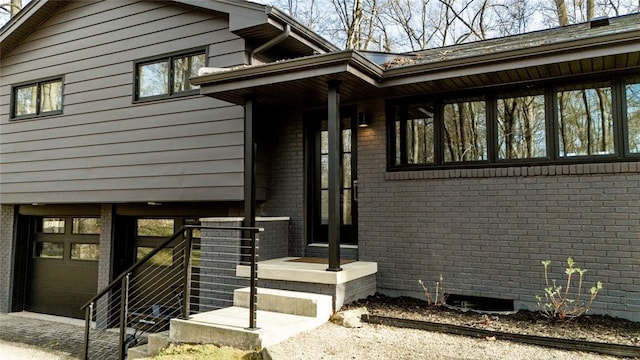 view of exterior entry featuring brick siding