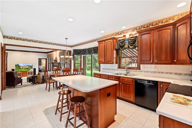 kitchen with a sink, dishwasher, a chandelier, a kitchen bar, and a center island
