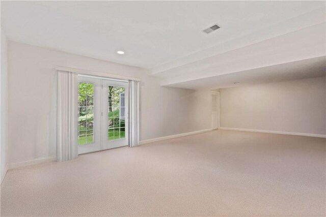 spare room featuring light carpet, baseboards, and recessed lighting