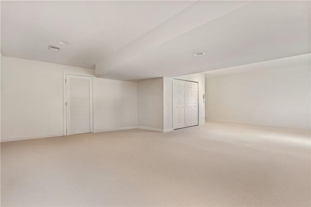 finished basement with light carpet and baseboards