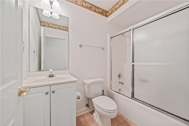 full bathroom with tile patterned floors, toilet, bath / shower combo with glass door, and vanity