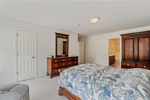 bedroom featuring light colored carpet, connected bathroom, and baseboards