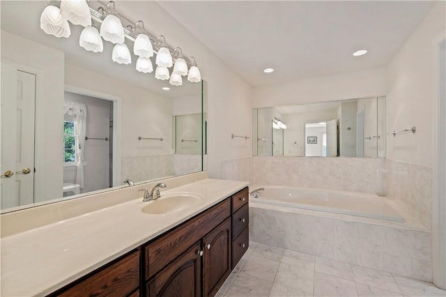 bathroom featuring marble look tile flooring, a bath, vanity, toilet, and recessed lighting