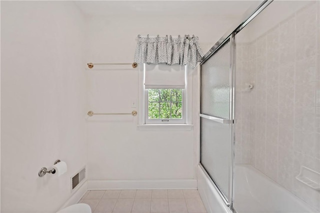 full bath featuring tile patterned flooring, baseboards, and enclosed tub / shower combo