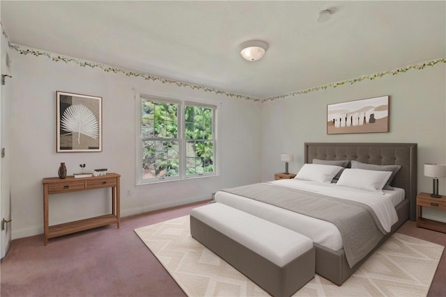 bedroom featuring baseboards and light carpet